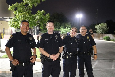 Four police officers standing together.