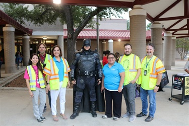 Batman standing in the center of a group of Vision Zero staff.