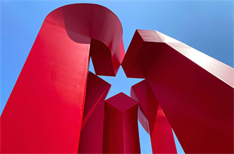 A large red sculpture with a star opening.