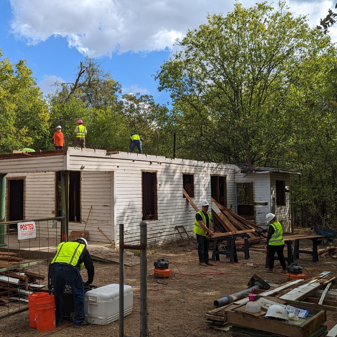 A Group of Construction workers rebuilding a home