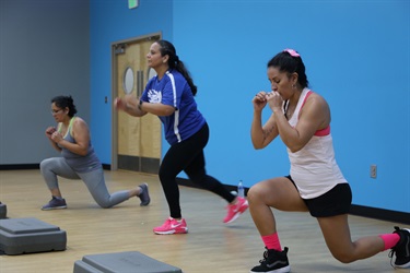 A diverse group of women performing squats.