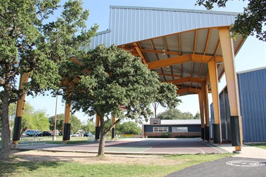 Covered basketball court with building on right side