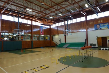 A gymnasium with multiple basketball hoops