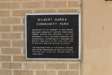 A plaque on a wall at Gilbert Garza Community Park, honoring its contribution to the community.