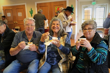 Three seniors enjoying a snack
