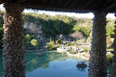 A serene pond, reflecting the sky and surrounding greenery at the Japanese Tea Garden.