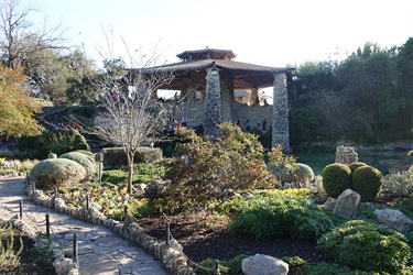 Scenic stone path winding through lush garden to charming gazebo at the Japanese Tea Garden.
