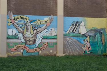 A mural of a Native American man painted on a building.