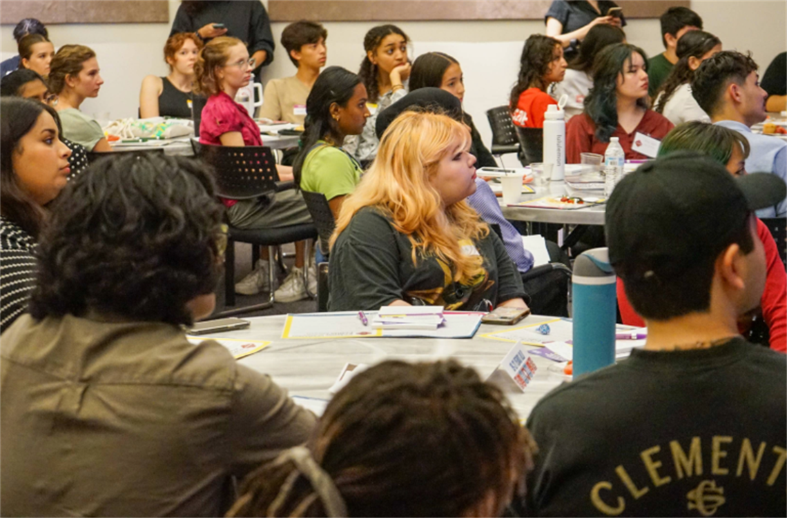 Students in a classroom listening to a presentation.