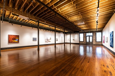 Open room displaying the Status of Women exhibition.