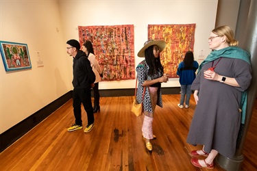 Guests mingle at the opening reception for the Between Yesterday and Tomorrow exhibitions.